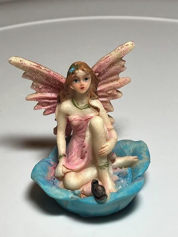 Miniature Pink Wing Fairy Sitting on a Blue Flower