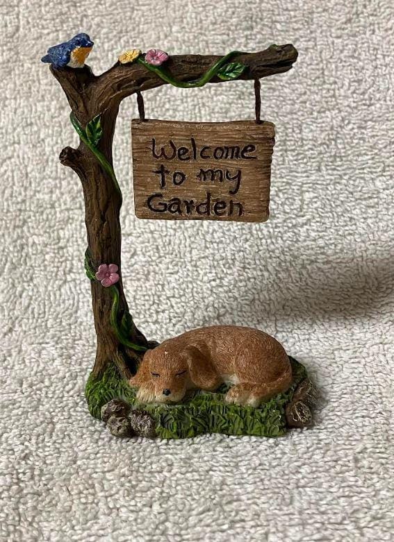 Miniature Dog Sleeping under a Welcome Sign Fairy Garden Figurine