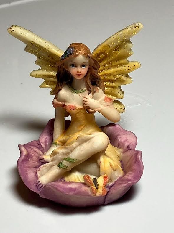 Miniature Yellow Wing Fairy Sitting on a Purple Flower