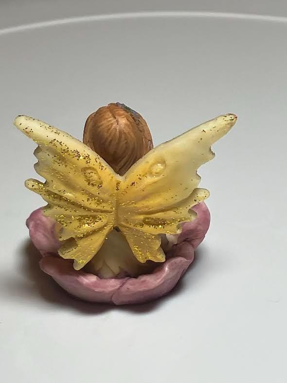 Miniature Yellow Wing Fairy Sitting on a Purple Flower